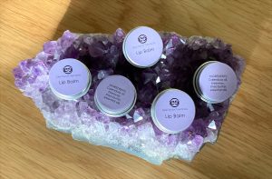 Lip balms showing ingredients list of calendula oil, beeswax, shea butter and essential oils